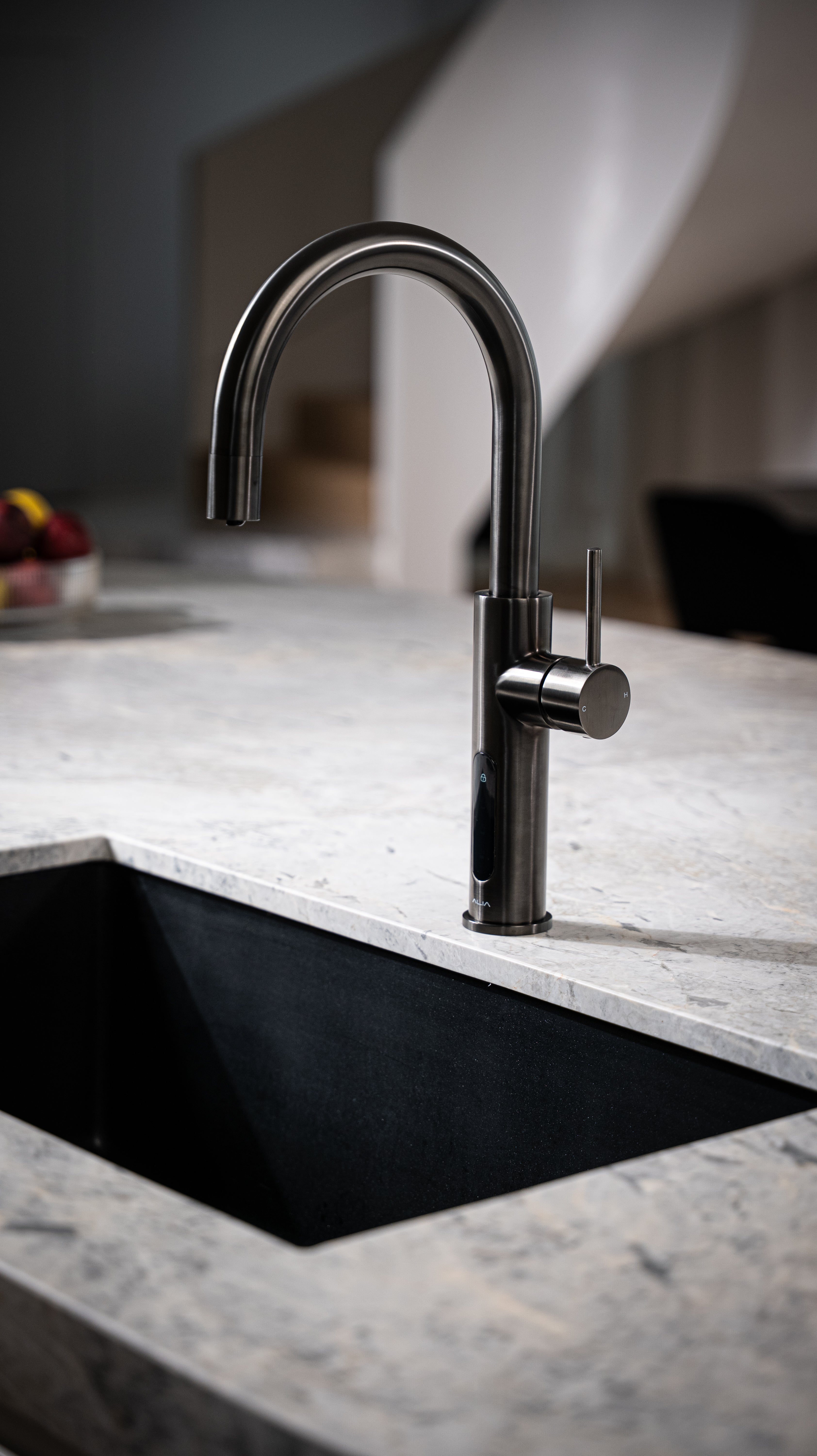 kitchen Alia X51 Gunmetal Grey Sparkling Boiling And Chilled water tap on a marble countertop with a modern interior background