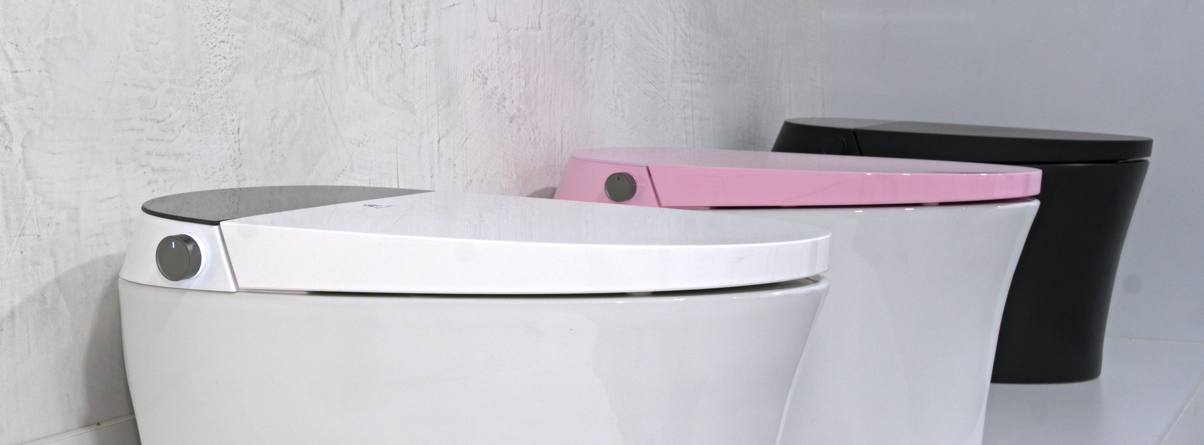 Banner featuring ALIA AG-ST1000 smart toilets with integrated bidet in three colours—white, pink, and matte black—highlighting multiple options for modern bathroom designs.