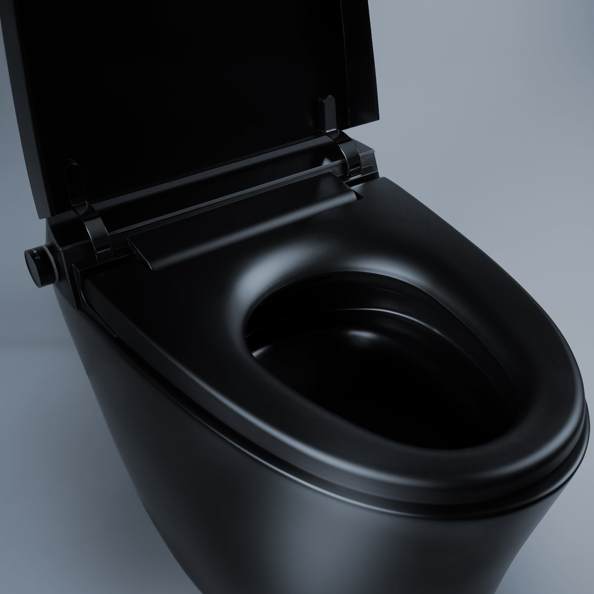 Detail shot of matte black Alia smart bidet toilet, focusing on bidet sprayer, buttons, and premium seat for advanced cleanliness and comfort.