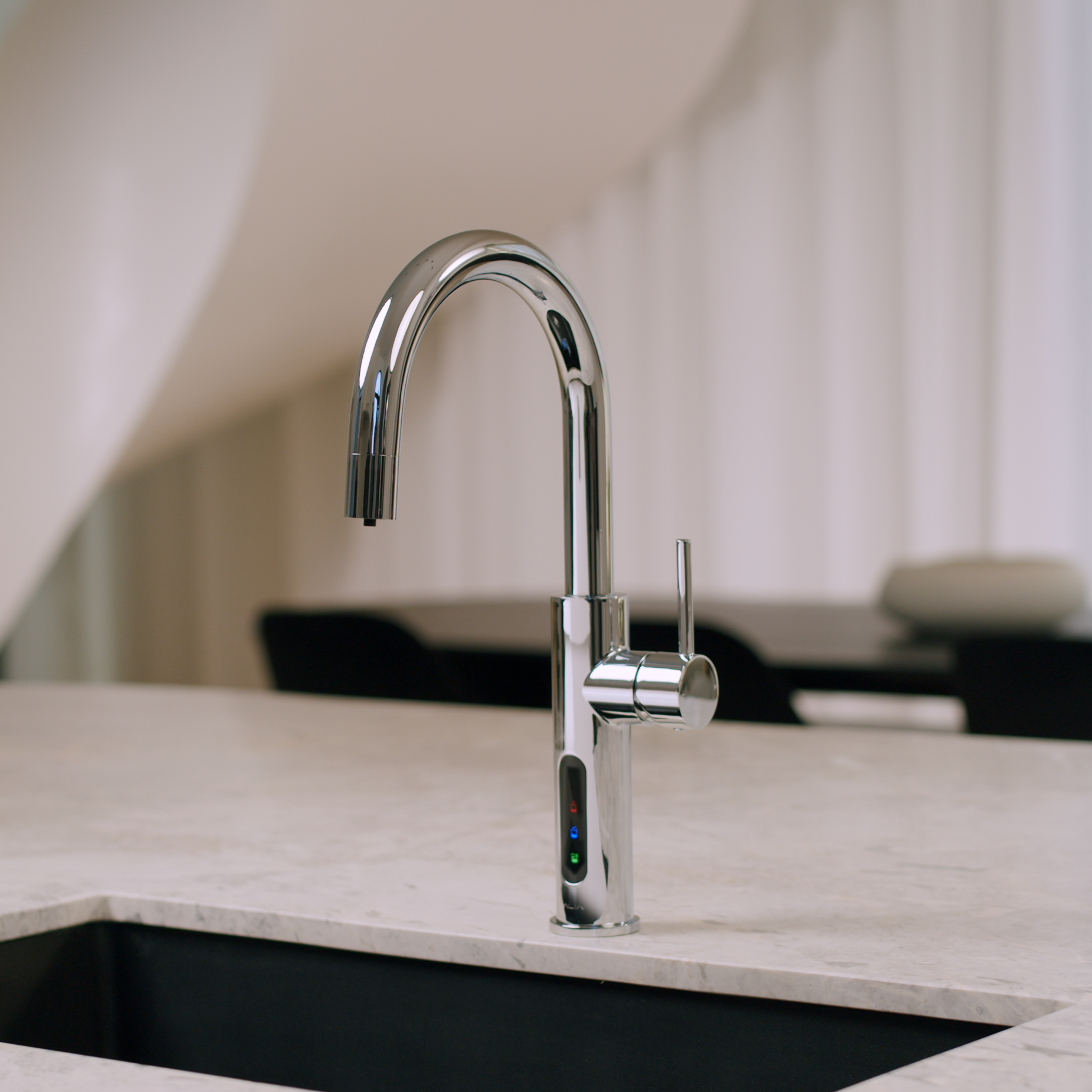 Alia X51 instant hot, cold, and sparkling filtered water tap in chrome finish shown installed in a stylish kitchen setting, highlighting advanced water filtration and elegant design.