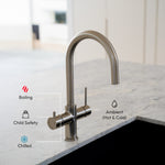 Modern Alia 4-in-1 Hot and cold water tap - kitchen faucet with Hot, cold, child safety and Ambient function icons - on a marble countertop
