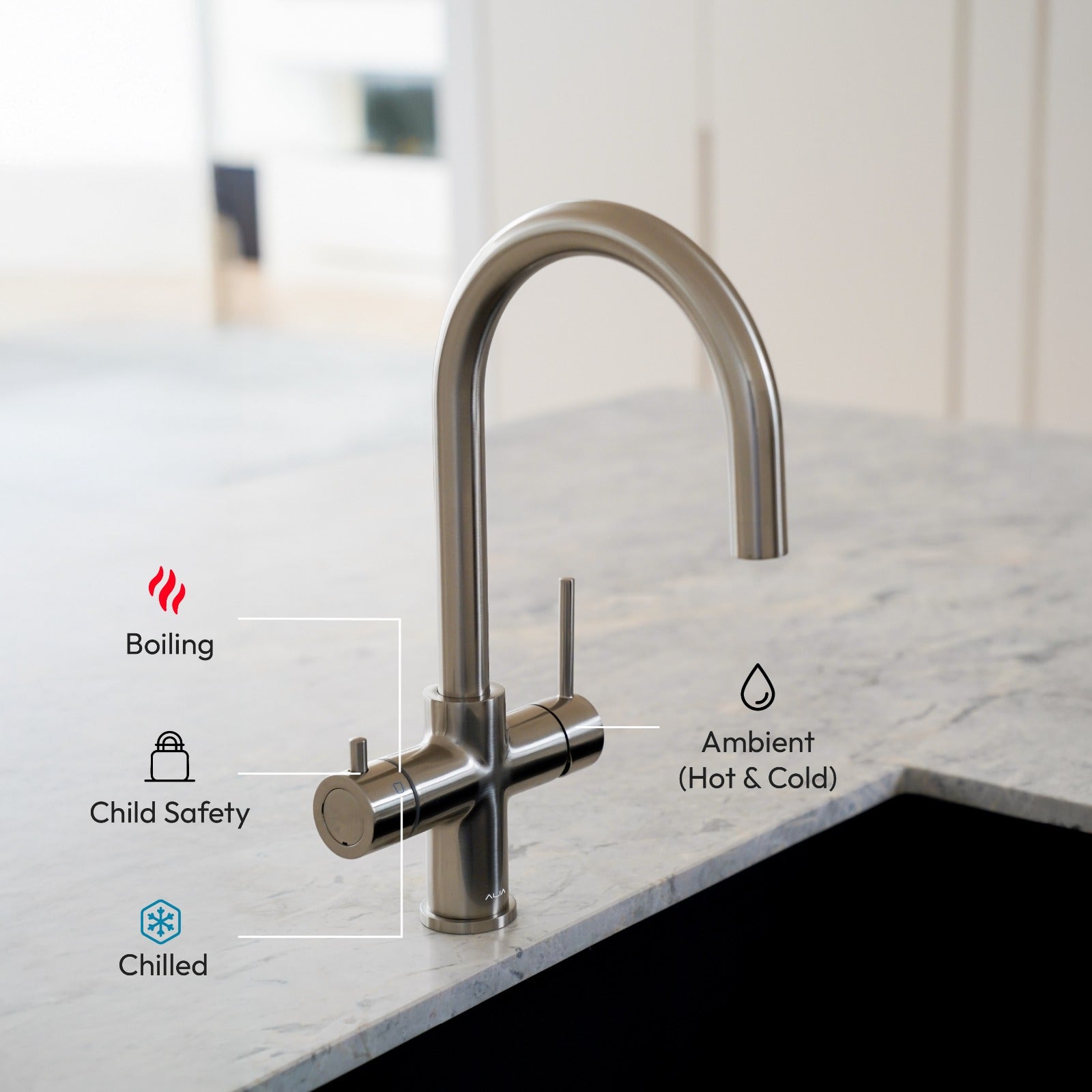 Modern Alia 4-in-1 Hot and cold water tap - kitchen faucet with Hot, cold, child safety and Ambient function icons - on a marble countertop
