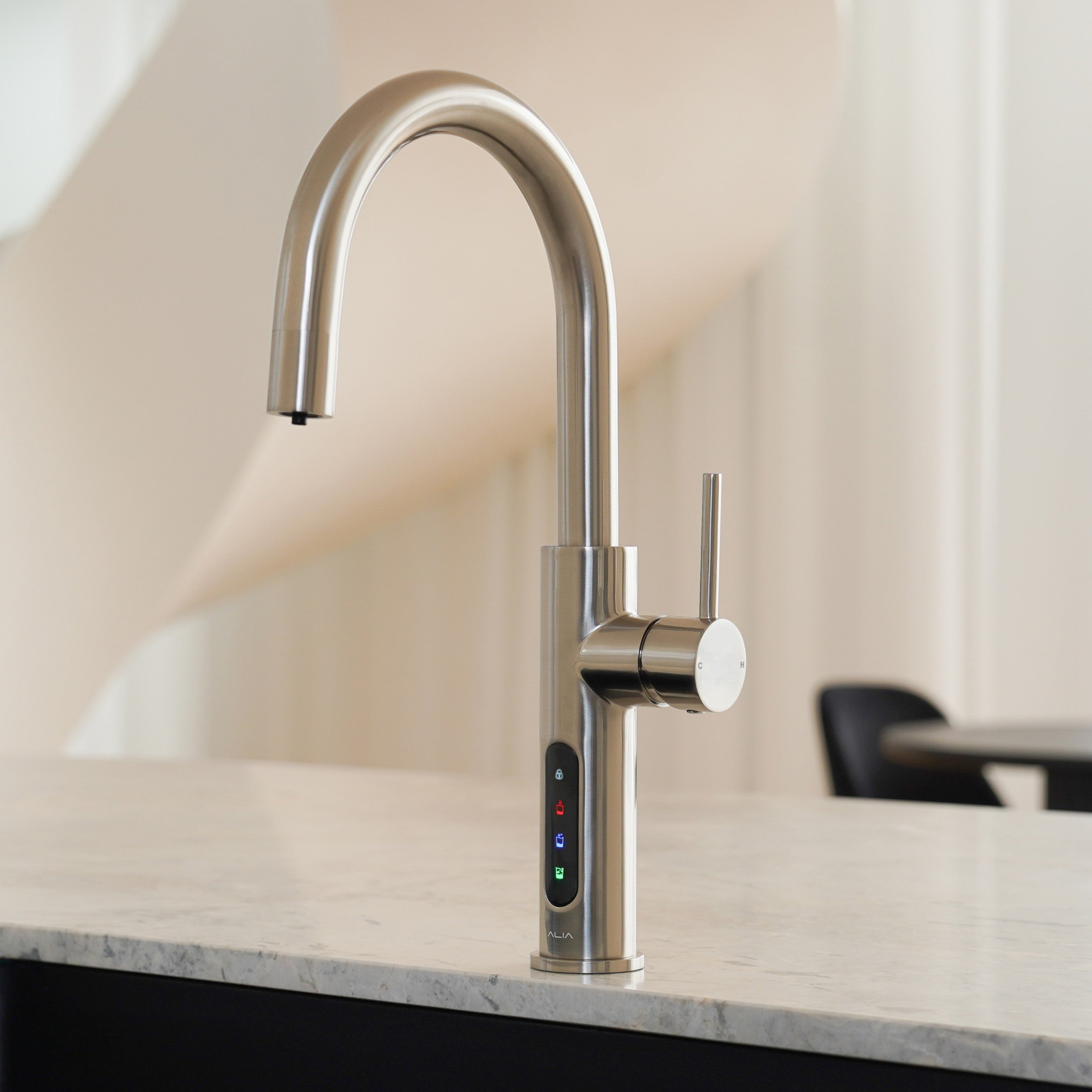 X51 brush Gold kitchen faucet on a marble countertop with a blurred background. Showcasing Boiling, Chilled and Sparkling Alia System.