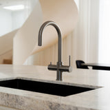 Gunmetal grey Alia Global 4-in-1 instant hot filtered water tap featured in a beautiful kitchen, offering filtered water and instant boiling water with sophisticated style.