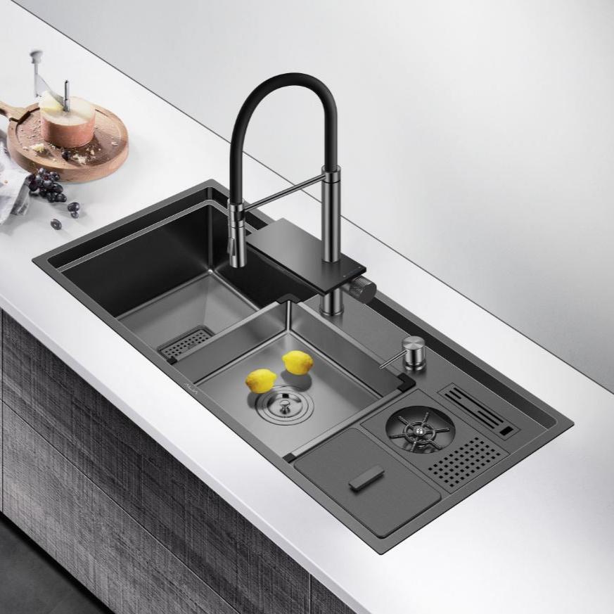 The ALIA Smart Sink in a stylish modern kitchen, custom-made from premium 3mm stainless steel with PVD coating, showcases dual bowls, multifunctional accessories, and innovative mixer tap for maximum efficiency.
