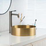 Close-up of installed ALIA brushed gold bathroom sink showcasing its reflective surface, smooth curves, and luxurious modern appeal.