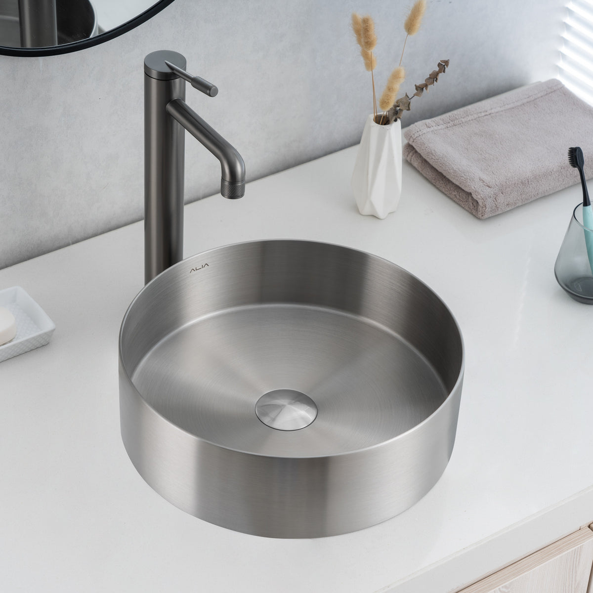 Real image of ALIA brushed silver round basin installed on a countertop, highlighting its subtle metallic sheen and clean design.