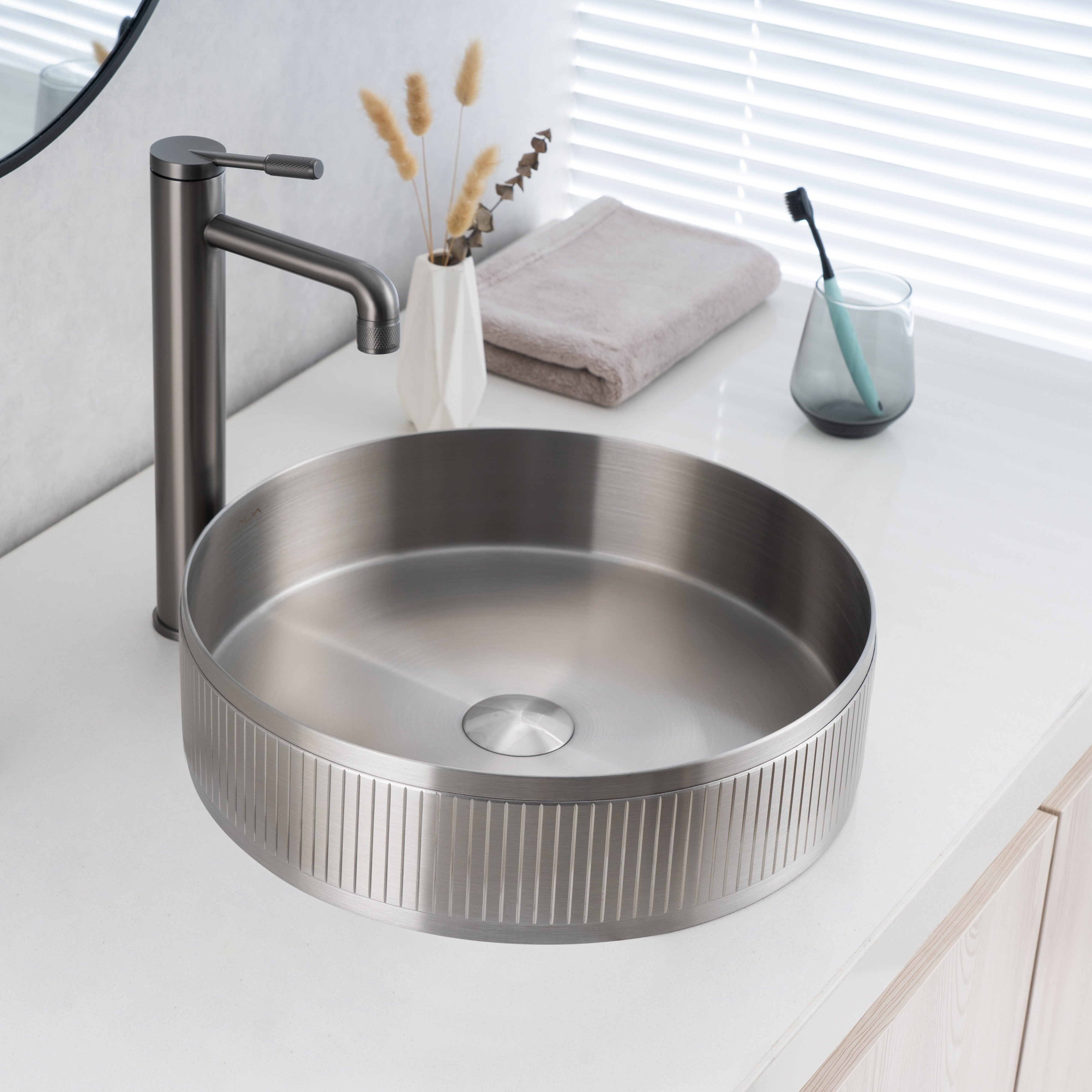 Real image of ALIA textured brushed silver round basin installed on a modern vanity, showing its subtle grain pattern and cool metallic tone.