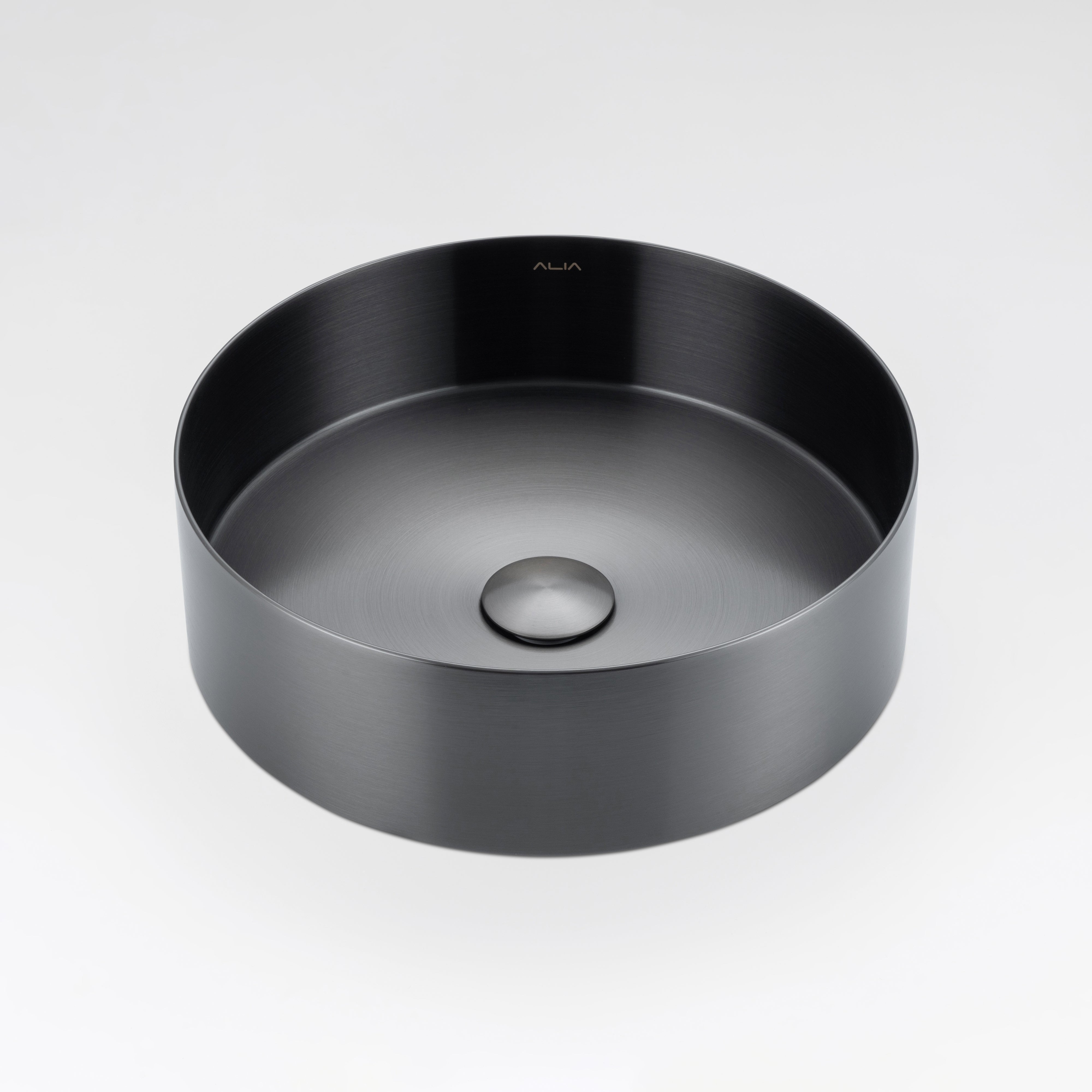 Gunmetal grey round stainless steel basin by ALIA designed for elegant, minimalist bathroom interiors. Black round sink on a light gray background.