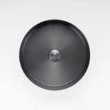 ALIA gunmetal grey stainless steel basin combines durability and contemporary aesthetics for modern bathrooms. Round black sink with a silver drain on a white background.