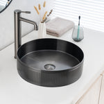 Real image of ALIA textured gunmetal grey round basin installed on a vanity, showcasing its matte surface and detailed texture.