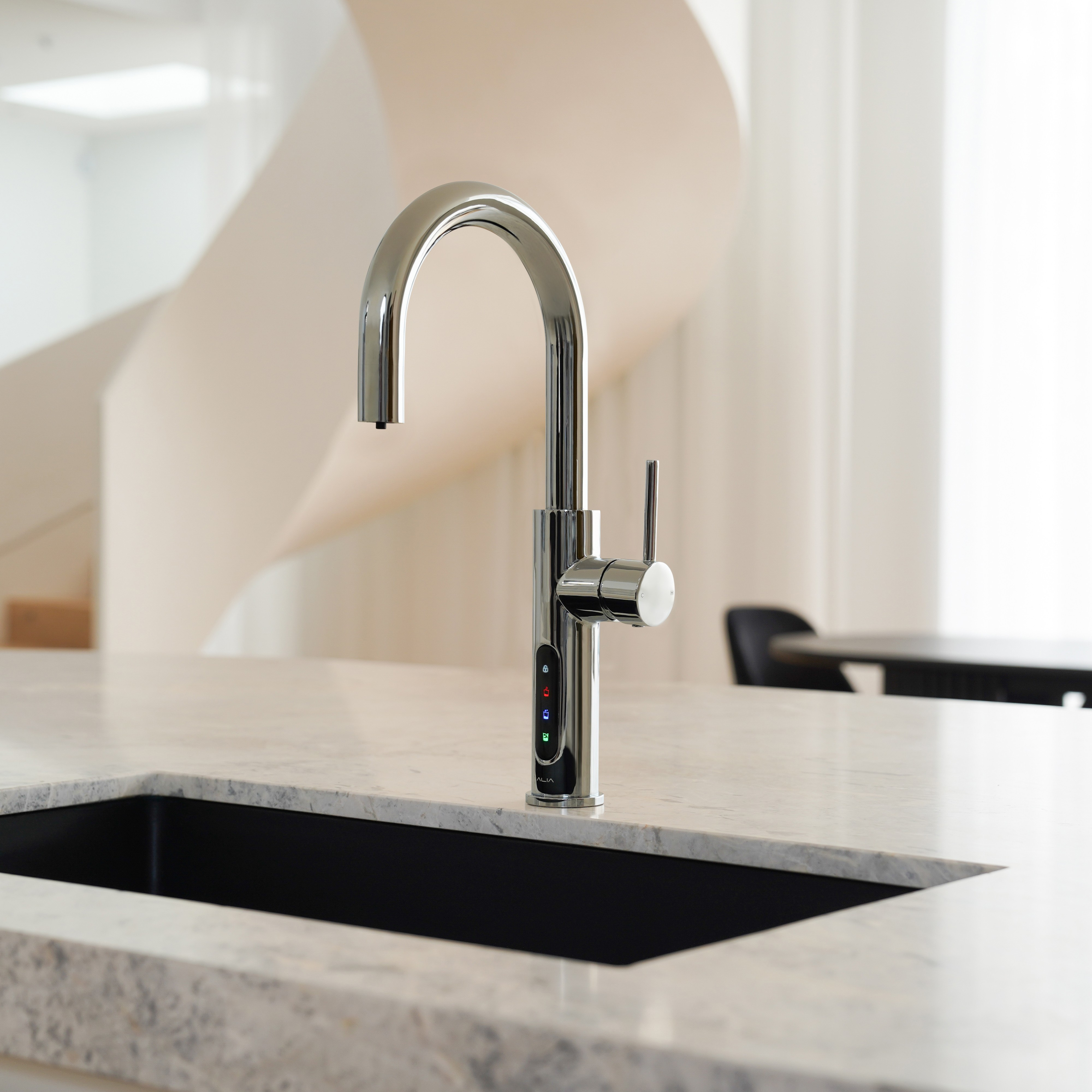 Alia X51 instant hot, cold, and sparkling filtered water tap in chrome finish shown installed in a stylish kitchen setting, highlighting advanced water filtration and elegant design.